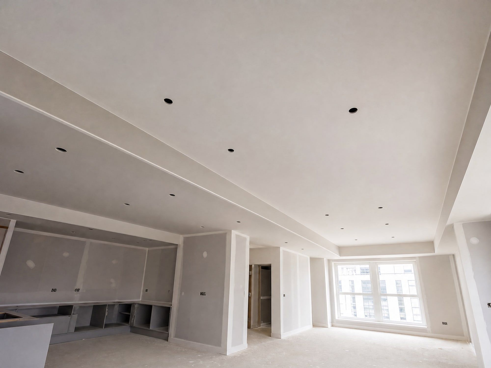 Illustration: a finished plasterboard ceiling with a long boxed bulkhead and downlight cut-outs
