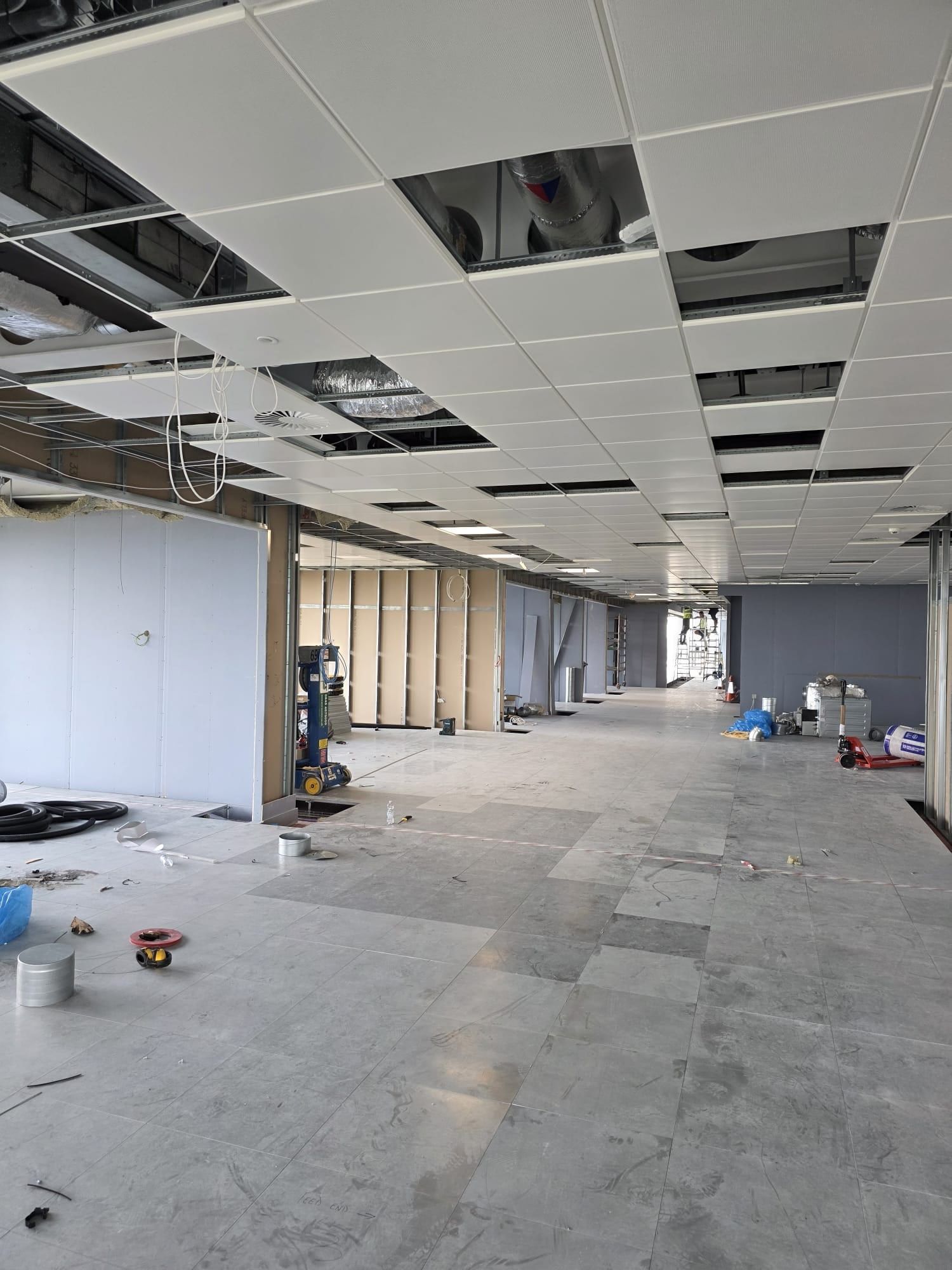 An open-plan office fit-out with new partitions and a suspended ceiling